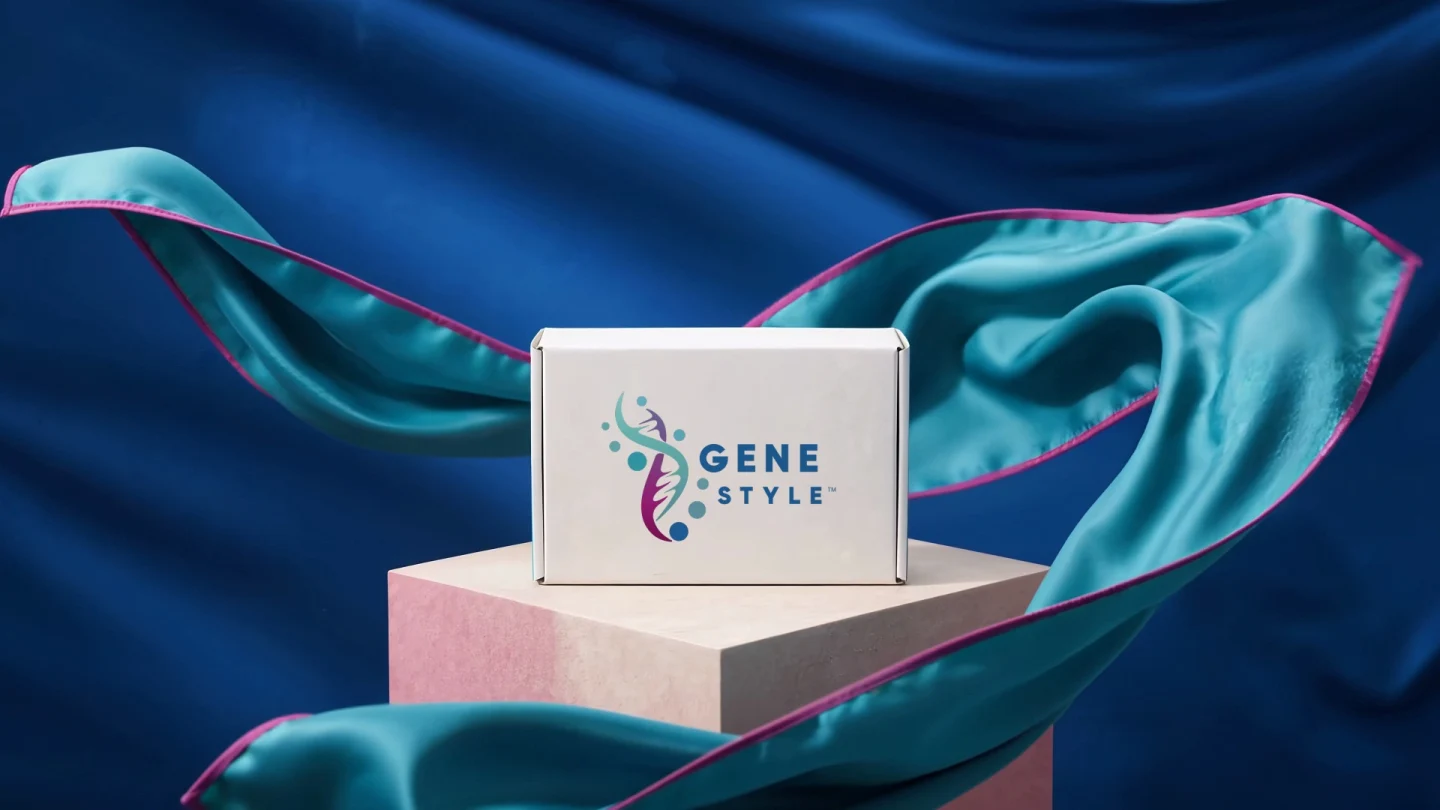 A teal silk scarf with magenta edging flowing around a test-kit box against a deep blue backdrop