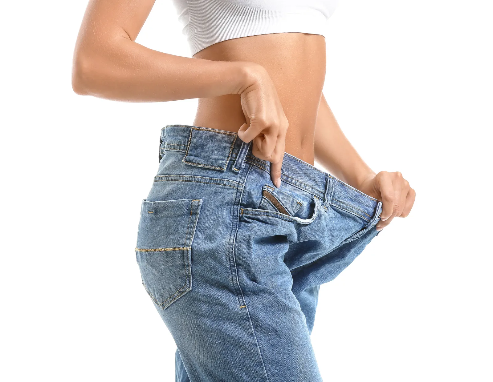 An image of a woman wearing oversized pants to illustrate weight loss without exercise.