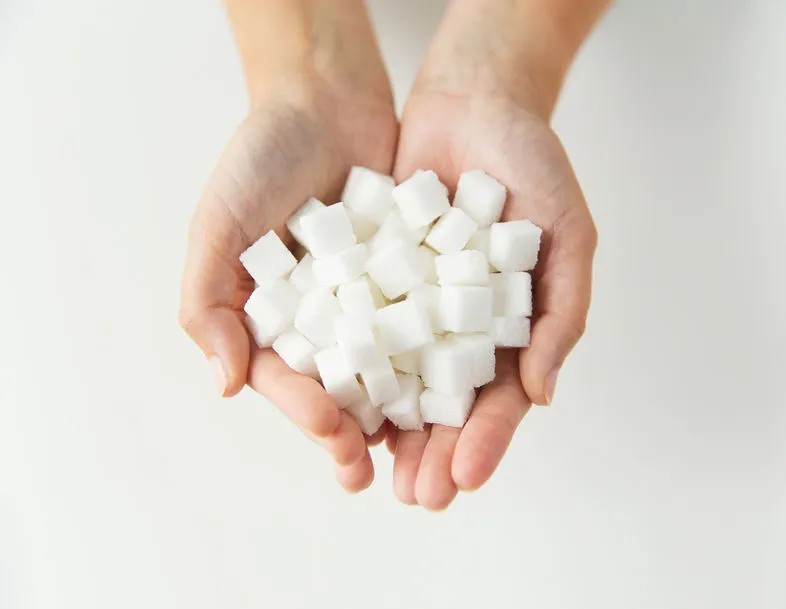 An image of a handful of sugar cubes to illustrate alternatives to sugar.