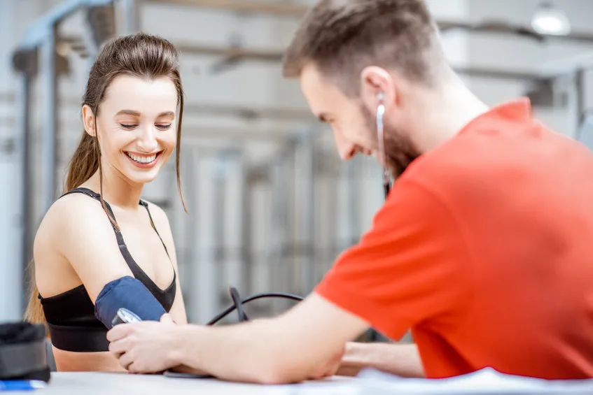 An image of man checking a woman's blood pressure to illustrate